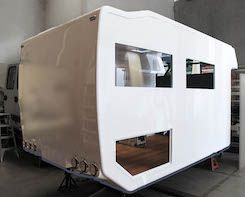 Image shows the final camper body with fibreglass end caps and composite side walls ready for windows and hatch doors to be fitted by Good Times RV